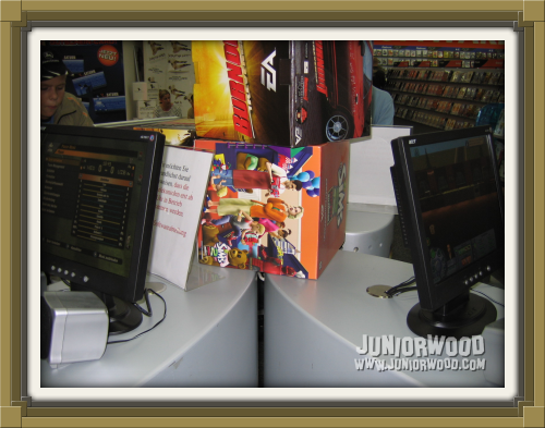 Demo computers with promotional Sims and Burnout Revenge items in between